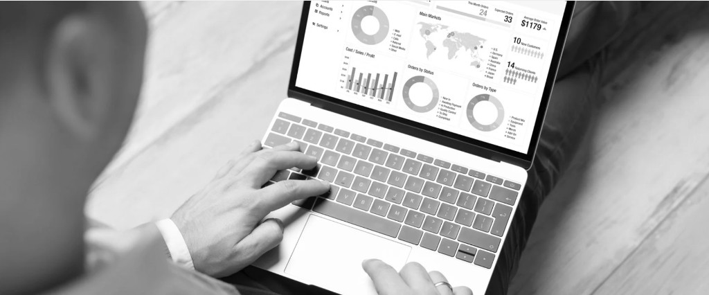 Professional reviewing CRM dashboard with customer and order analytics